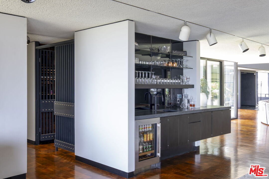 1100 Paso Alto Road Pasadena, CA 91105 - Photo 12 of 21 a kitchen with stainless steel appliances granite countertop a refrigerator and a wooden floor