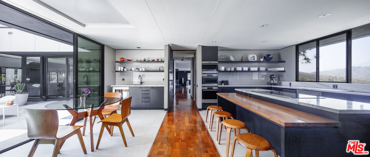 1100 Paso Alto Road Pasadena, CA 91105 - Photo 7 of 21 a kitchen with stainless steel appliances granite countertop a sink and chairs