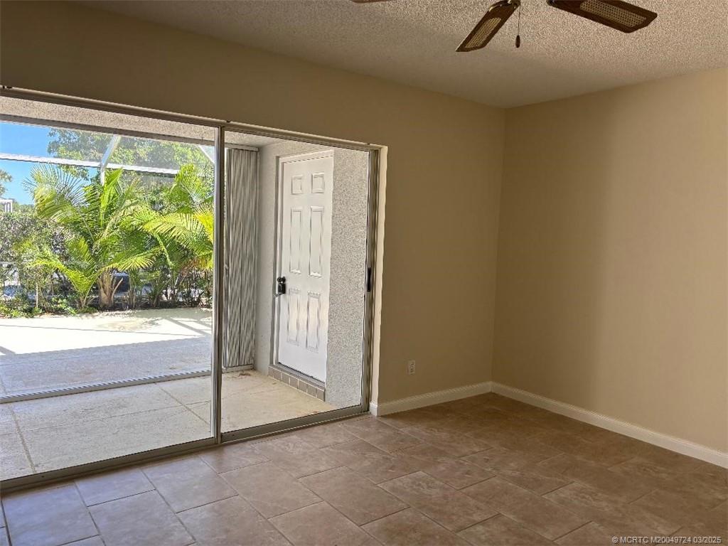 1559 Southwest Waterfall Boulevard Palm City, FL 34990 - Photo 12 of 19 Guest bedroom looks onto the lanai