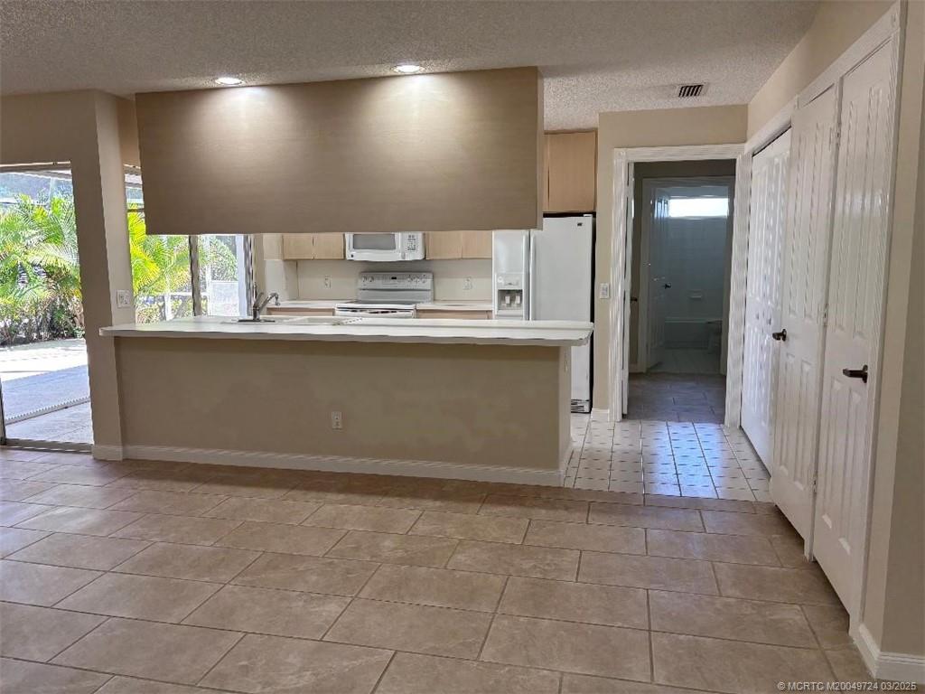 1559 Southwest Waterfall Boulevard Palm City, FL 34990 - Photo 16 of 19 Kitchen open to living room