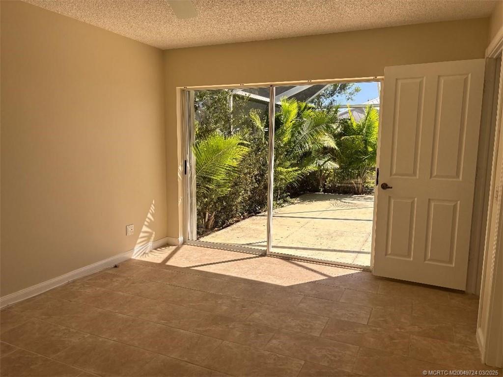 1559 Southwest Waterfall Boulevard Palm City, FL 34990 - Photo 7 of 19 Master bedroom looks onto the lanai