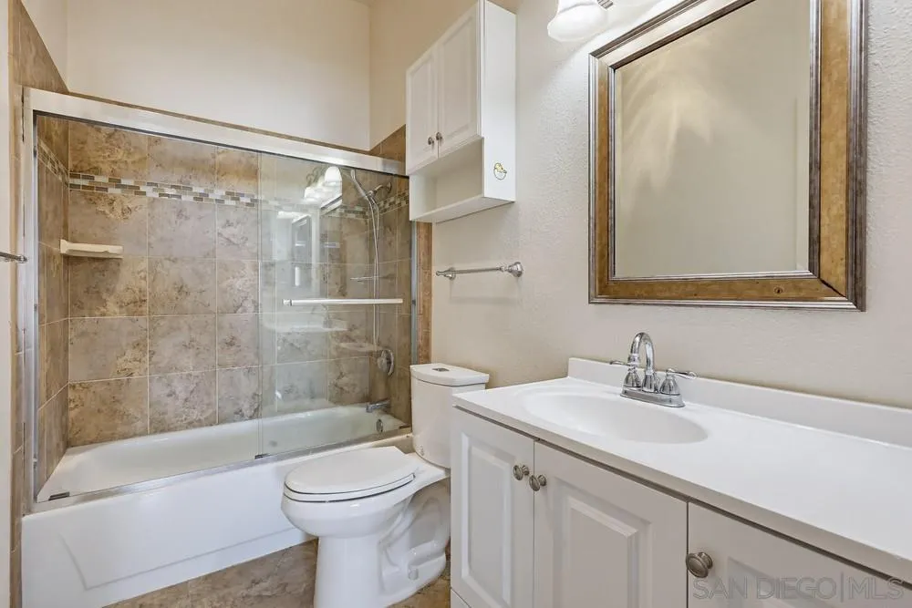8324 Regents Road, Unit 2E San Diego, CA 92122 - Photo 22 of 31 a bathroom with a sink mirror toilet and bathtub