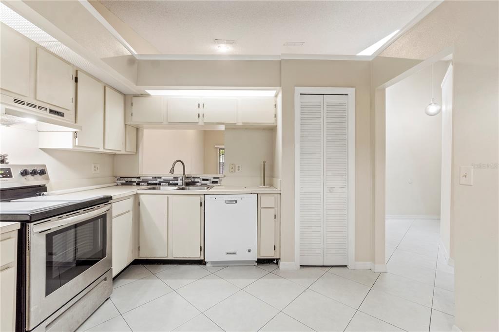 623 Red Oak Circle, Unit 121 Altamonte Springs, FL 32701 - Photo 11 of 24 a kitchen with white cabinets and white appliances