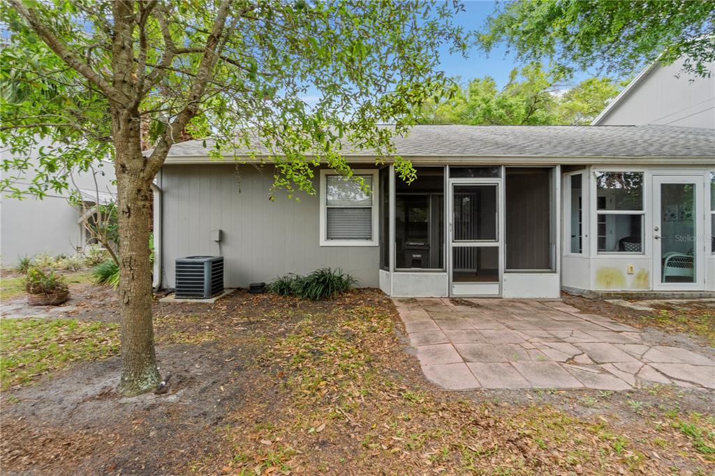 623 Red Oak Circle, Unit 121 Altamonte Springs, FL 32701 - Photo 23 of 24 a front view of a house with a yard and garage