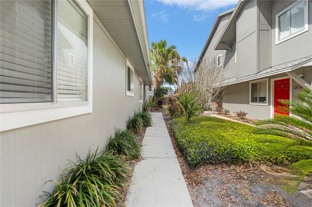 623 Red Oak Circle, Unit 121 Altamonte Springs, FL 32701 - Photo 3 of 24 a view of a pathway with house on both side