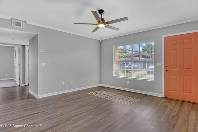 wooden floor in an empty room with a window