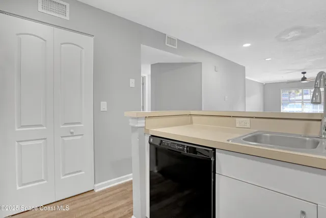 a kitchen with a sink and a wooden cabinets