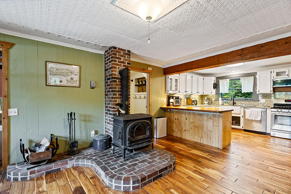 14 South Hatch Hill Road Greene, ME 04236 - Photo 6 of 56 Wood stove and kitchen