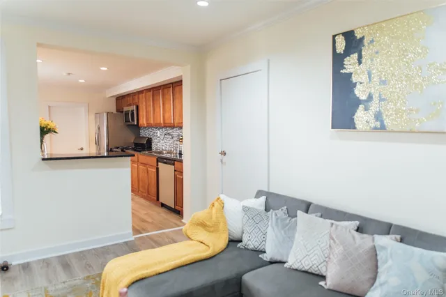 a living room with a couch and kitchen view