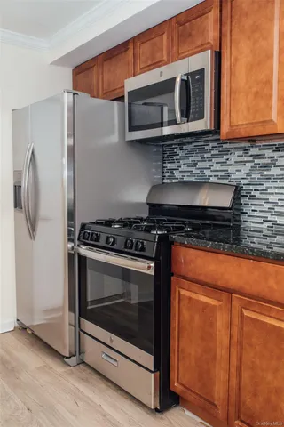 a kitchen with stainless steel appliances granite countertop cabinets and a stove top oven