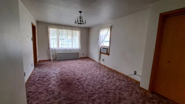a view of room with window and hardwood floor