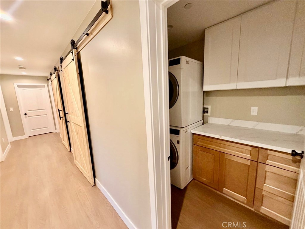 43290 Shasta Road Big Bear Lake, CA 92315 - Photo 22 of 36 a view of a kitchen with fridge and wooden floor