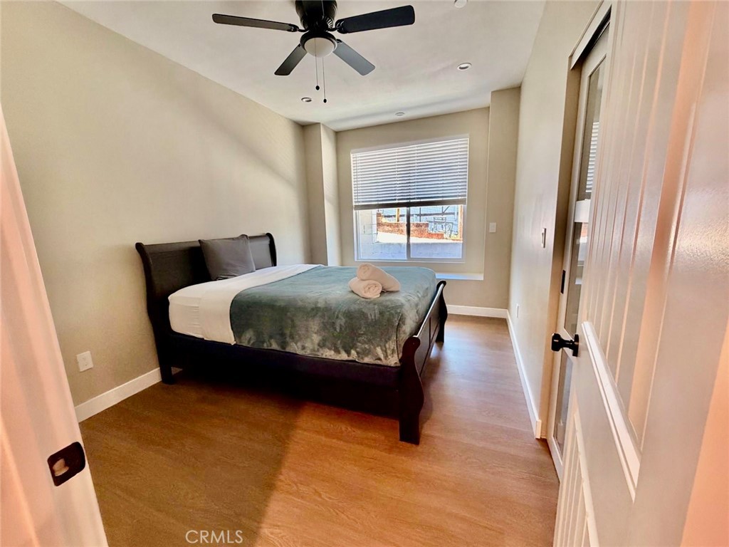 43290 Shasta Road Big Bear Lake, CA 92315 - Photo 23 of 36 a bedroom with a bed window and a ceiling fan