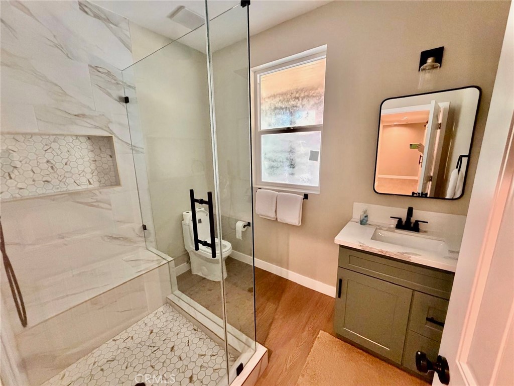 43290 Shasta Road Big Bear Lake, CA 92315 - Photo 26 of 36 a en suite bathroom with a double vanity sink a mirror and a bathtub
