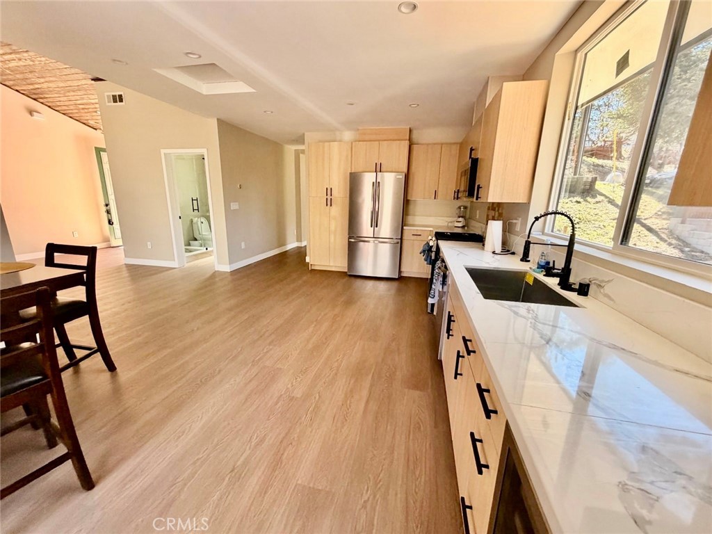 43290 Shasta Road Big Bear Lake, CA 92315 - Photo 32 of 36 a view of a kitchen with furniture and wooden floor