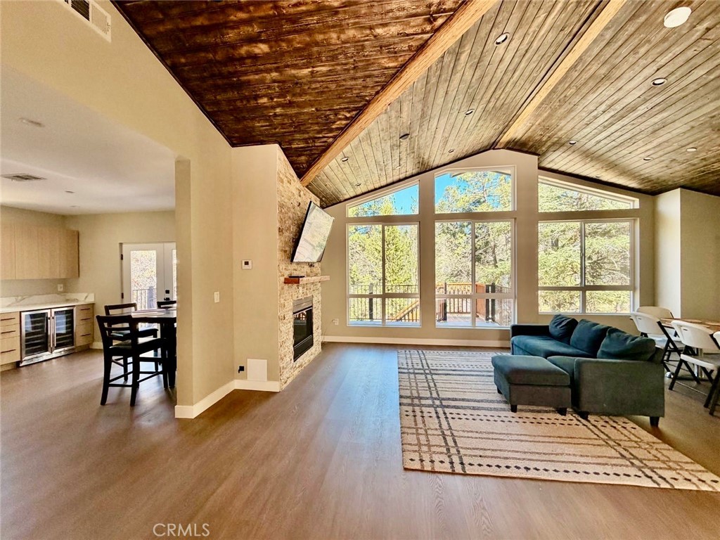 43290 Shasta Road Big Bear Lake, CA 92315 - Photo 34 of 36 a living room with furniture a wooden floor and next to a window
