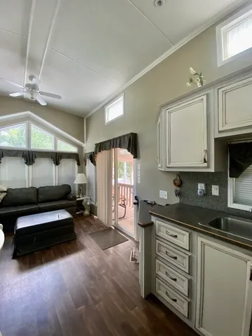 a kitchen with granite countertop a sink a stove and cabinets
