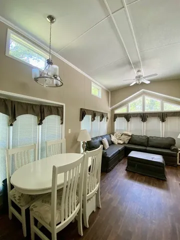 a view of a dining room with furniture wooden floor and chandelier