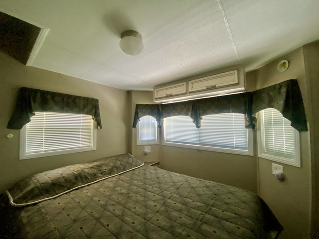 2-292 Woodhaven Sublette, IL 61367 - Photo 18 of 25 a bedroom with a bed and window