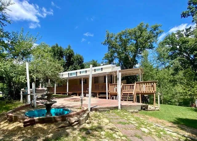 a view of a house with backyard porch and sitting area