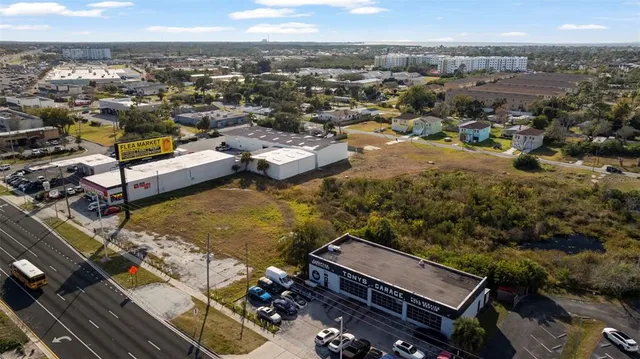 an aerial view of a house with a mountain
