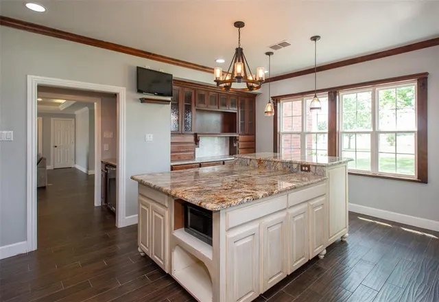a kitchen with stainless steel appliances granite countertop stove top oven and refrigerator