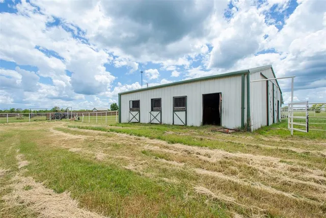 a house view with swimming pool in front of it