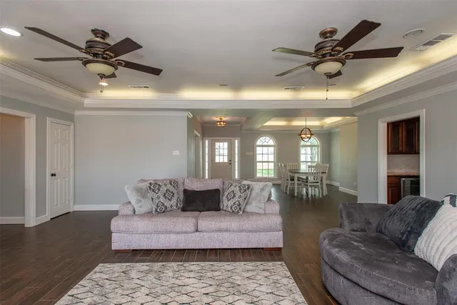 a living room with furniture and a ceiling fan