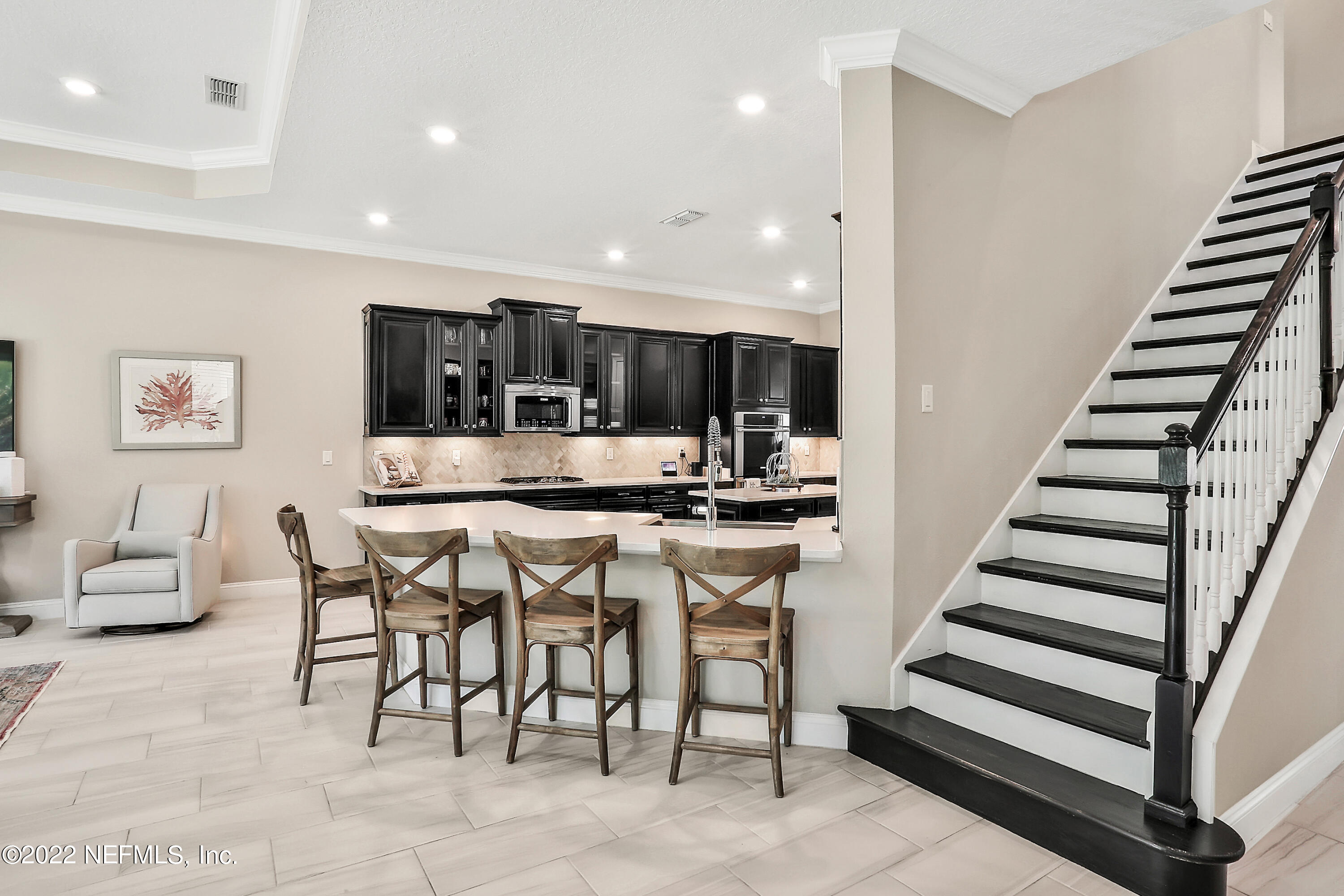 143 Barbella Circle St. Augustine, FL 32095 - Photo 17 of 95 a kitchen with stainless steel appliances kitchen island granite countertop a refrigerator and cabinets