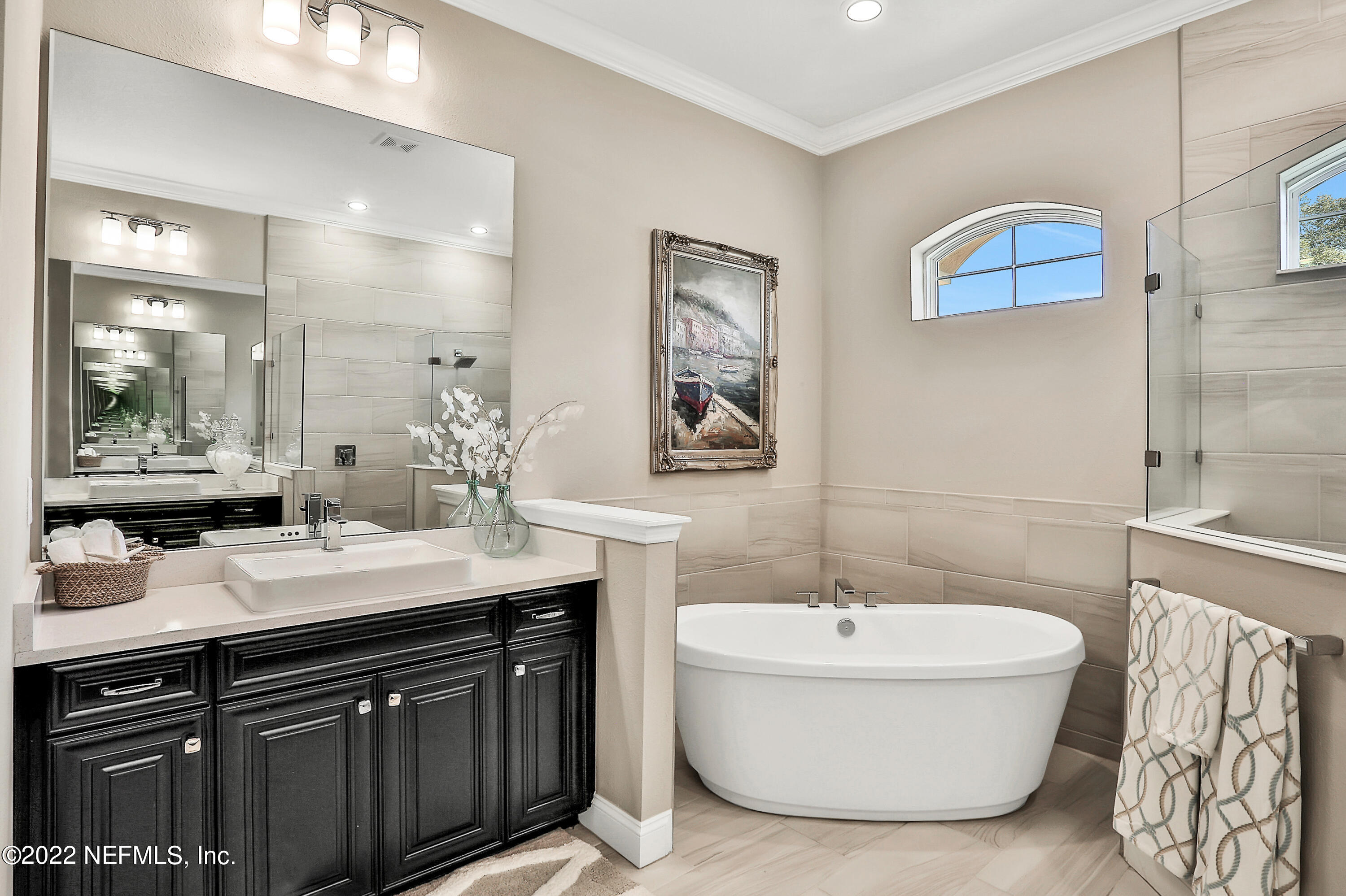 143 Barbella Circle St. Augustine, FL 32095 - Photo 34 of 95 a bathroom with a double vanity sink a mirror and a bathtub