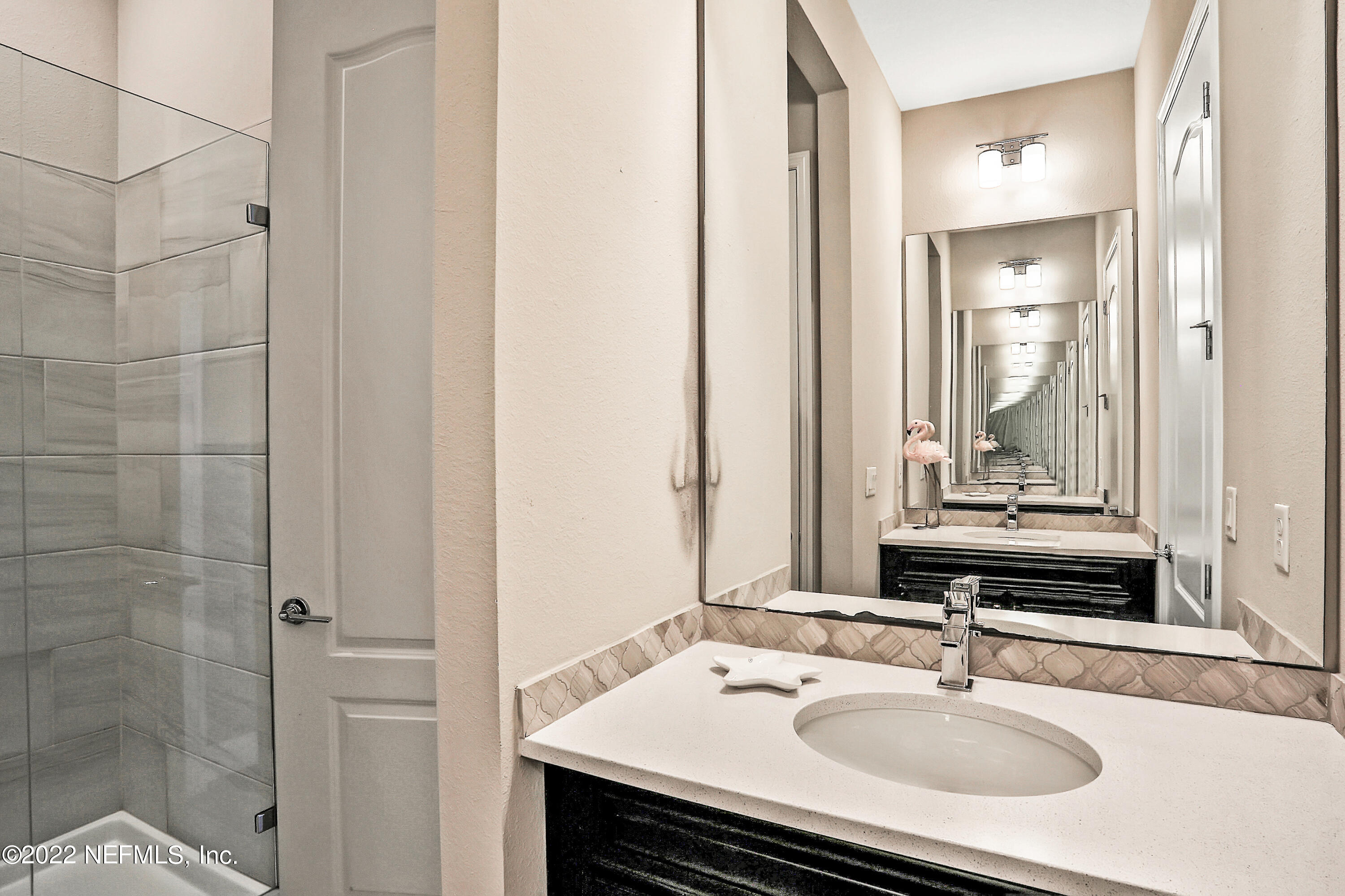 143 Barbella Circle St. Augustine, FL 32095 - Photo 51 of 95 a bathroom with a sink and a mirror