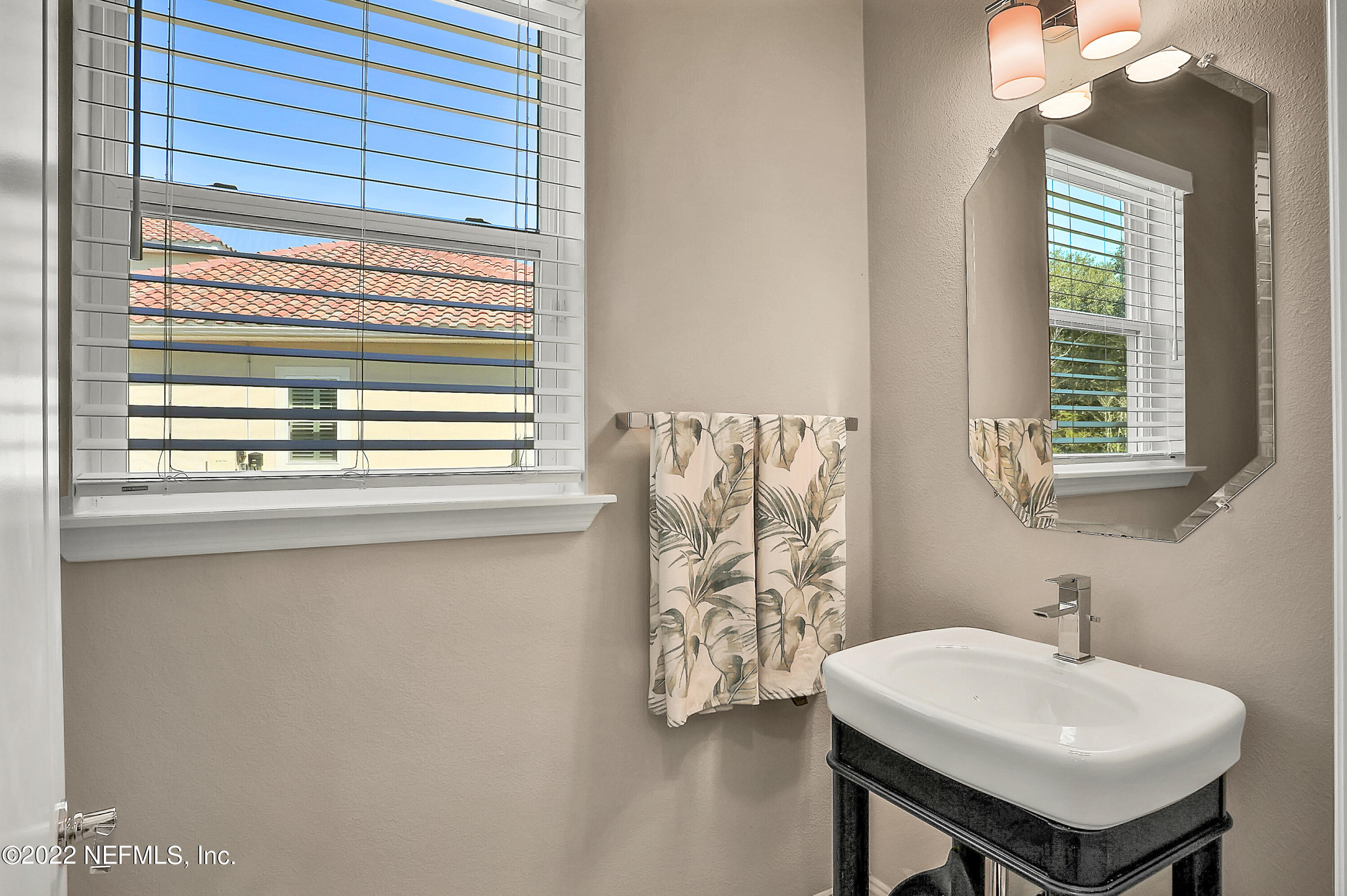 143 Barbella Circle St. Augustine, FL 32095 - Photo 54 of 95 a bathroom with a sink a mirror and a window