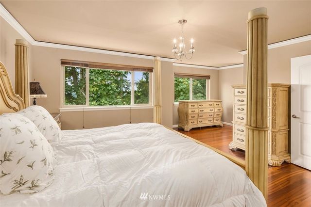 a spacious bedroom with a bed and a large window with outer view