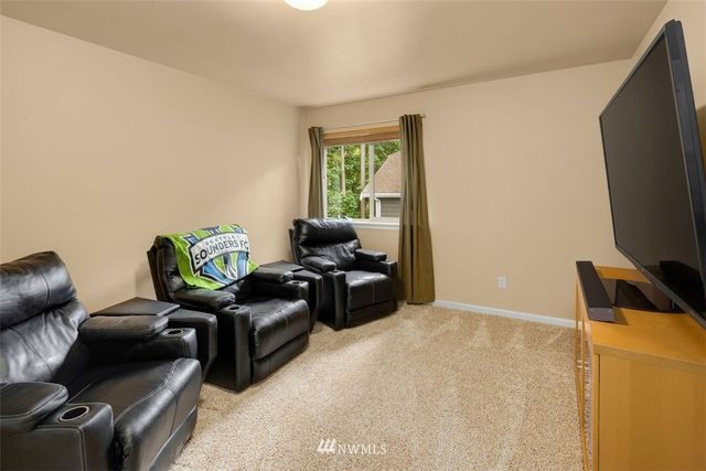 a bedroom with furniture and a flat screen tv