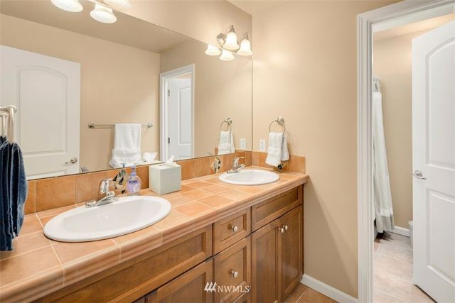 a bathroom with a sink double vanity and a mirror