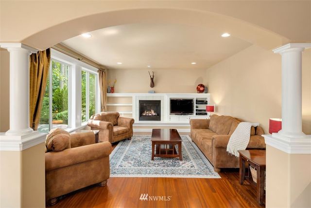 a living room with furniture flat screen tv and a large window