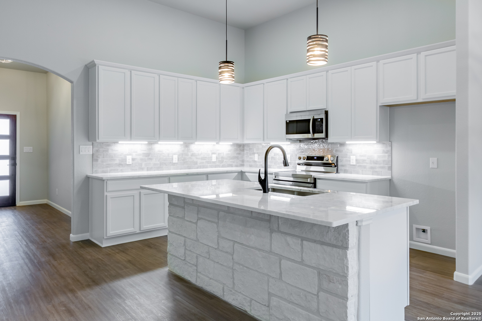 1841 Cottonwood Road Fischer, TX 78623 - Photo 15 of 45 a kitchen with kitchen island granite countertop a sink stainless steel appliances and white cabinets