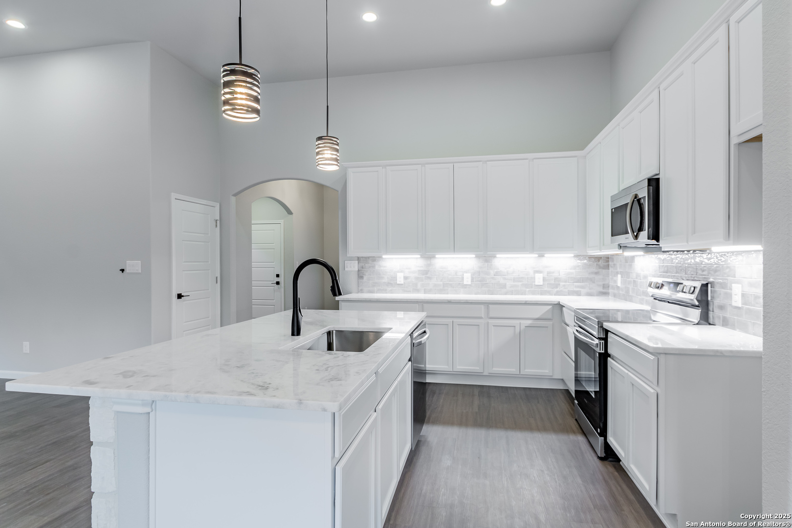 1841 Cottonwood Road Fischer, TX 78623 - Photo 17 of 45 a kitchen with kitchen island granite countertop a sink stainless steel appliances and white cabinets