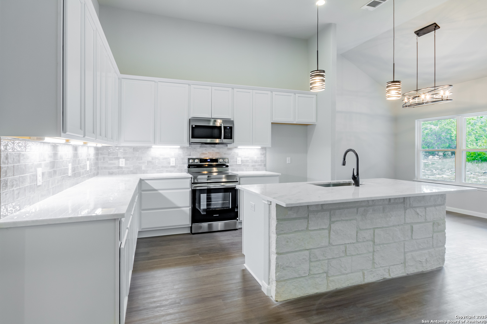 1841 Cottonwood Road Fischer, TX 78623 - Photo 19 of 45 a kitchen with kitchen island granite countertop a sink cabinets and stainless steel appliances