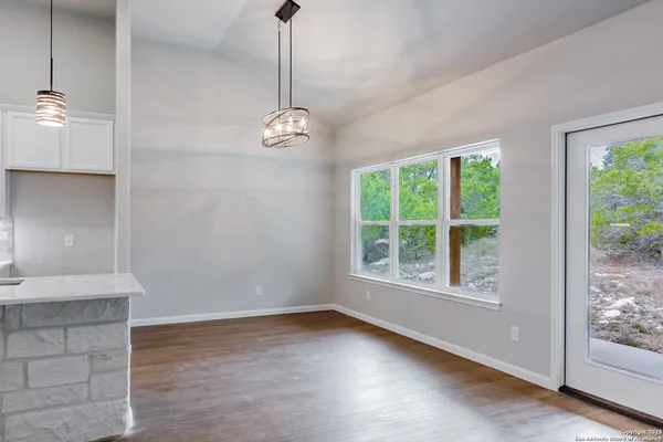 a view of empty room with wooden floor and outdoor view