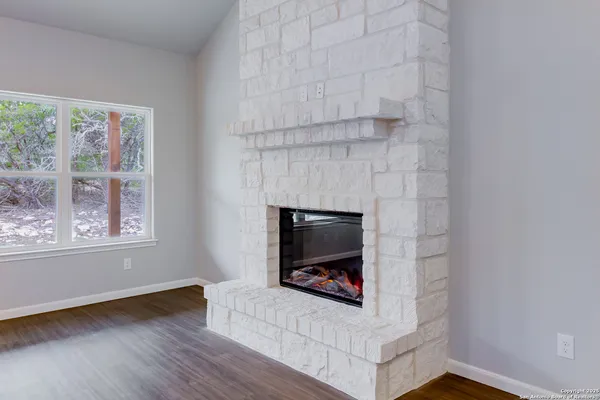 a living room with a fireplace and a floor to ceiling window