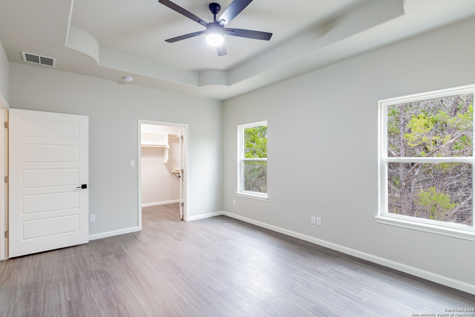 1841 Cottonwood Road Fischer, TX 78623 - Photo 26 of 45 a view of an empty room with a window and wooden floor