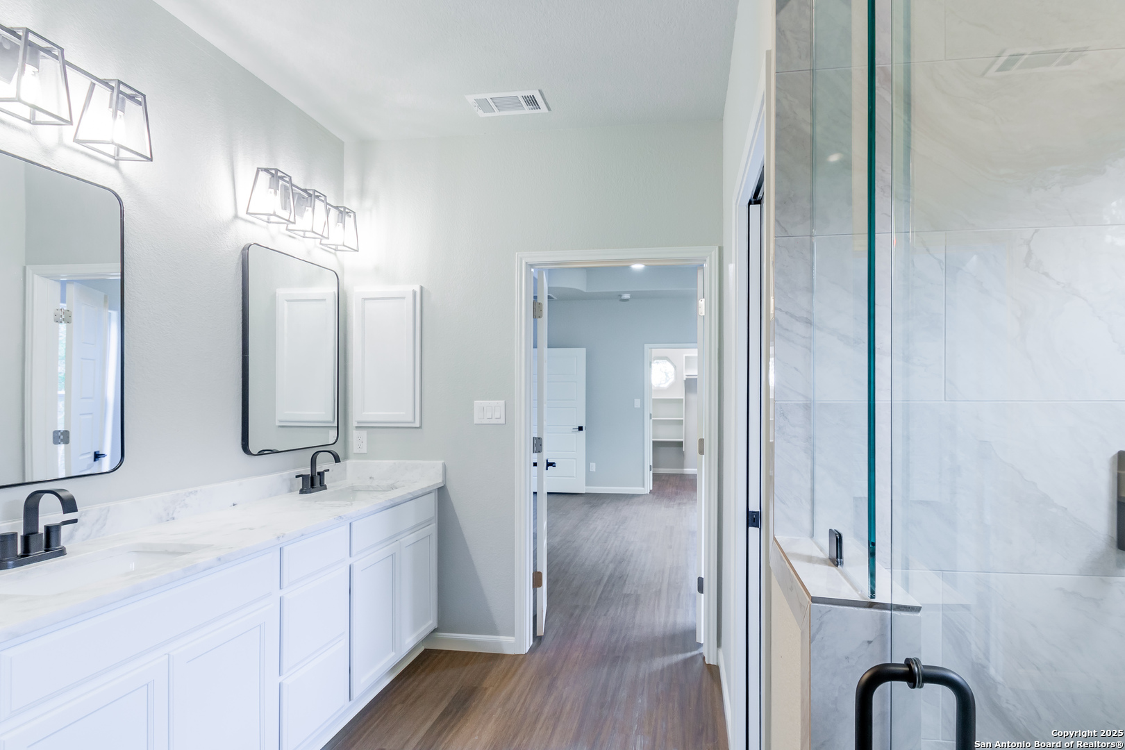 1841 Cottonwood Road Fischer, TX 78623 - Photo 27 of 45 a spacious bathroom with a double vanity sink a mirror and shower