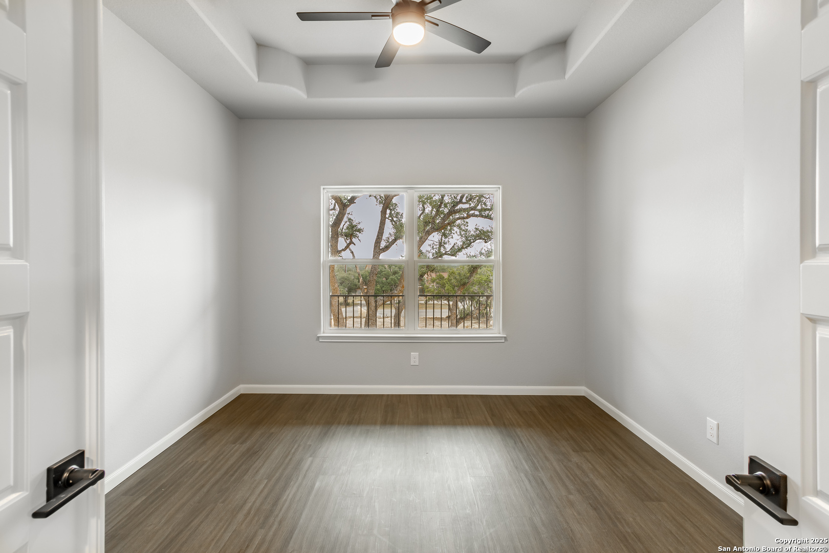 1841 Cottonwood Road Fischer, TX 78623 - Photo 37 of 45 an empty room with wooden floor and windows