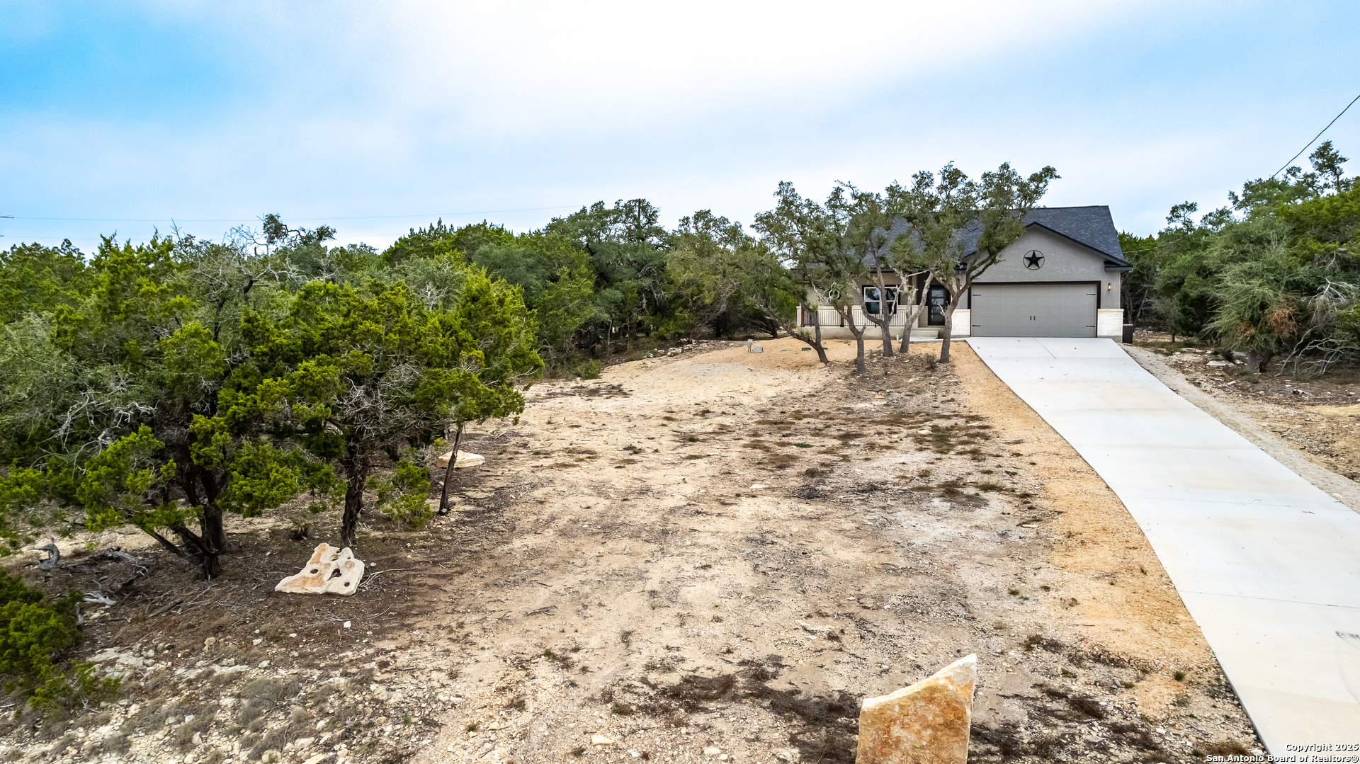 1841 Cottonwood Road Fischer, TX 78623 - Photo 6 of 45 a view of a dry yard with trees