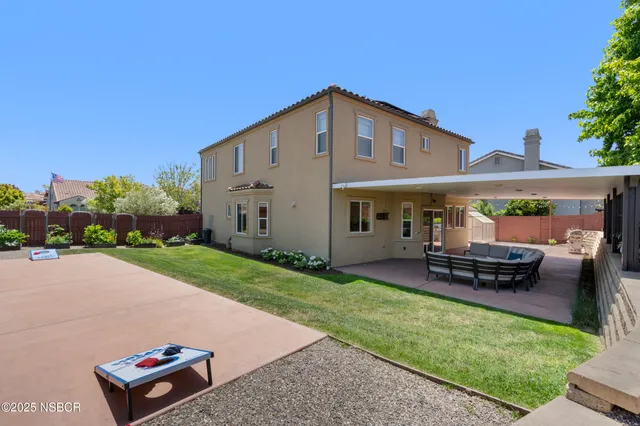 a front view of a house with a garden and patio