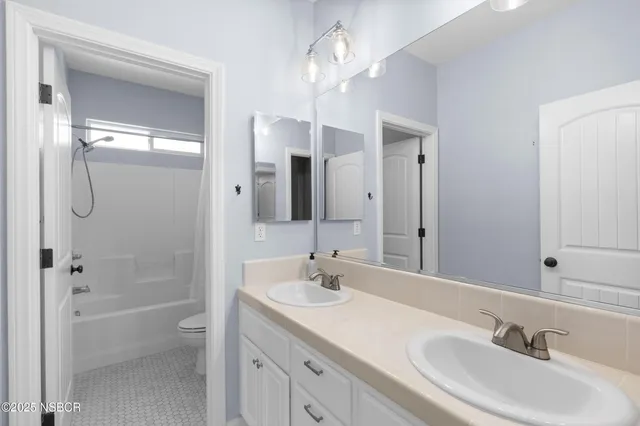 a bathroom with a sink double vanity granite tub and shower