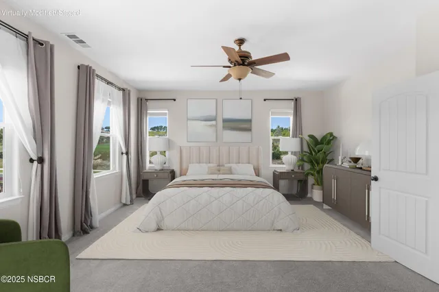 a bedroom with a large bed and a chandelier