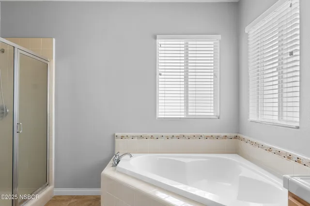 a white bath tub sitting next to a window