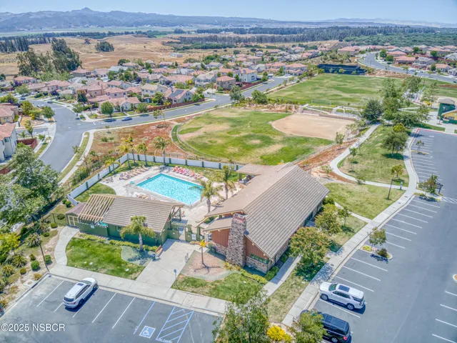 an aerial view of residential houses with outdoor space and river